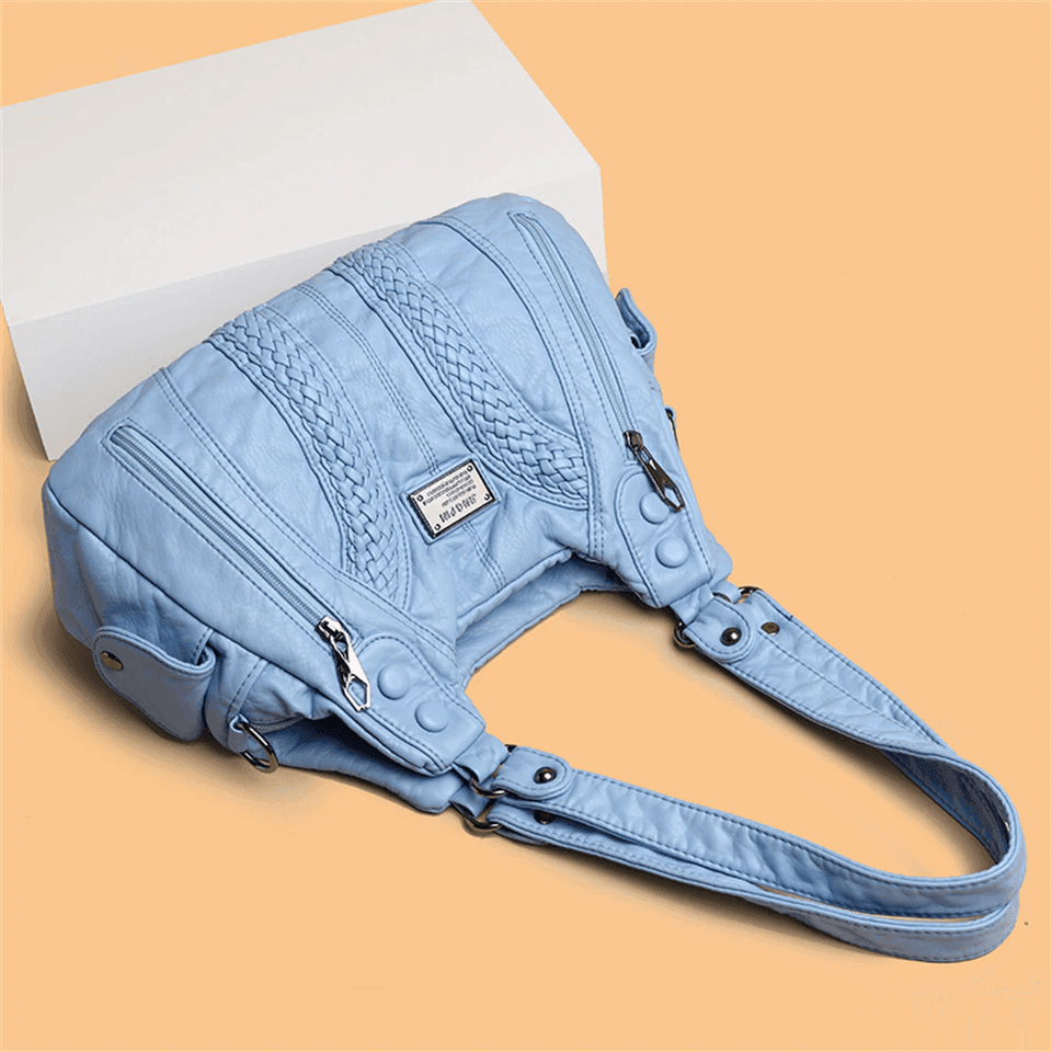 תיק עור מדליק של מעצב מניו יורק בגימור צמות מיוחד להופעה של אישה טרנדית חזקה - לה איסלה