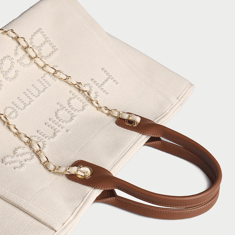 תיק בד של מותג ספרדי בשילוב חרוזי פנינה ובעיצוב מרשים להופעה נשית קלילה וטרנדית - לה איסלה